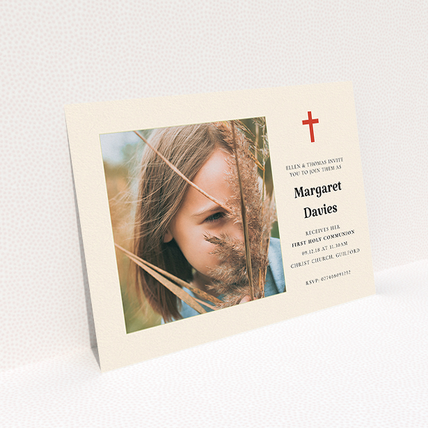 A communion invitation template titled "Red Cross". It is an A5 invite in a landscape orientation. It is a photographic communion invitation with room for 1 photo. "Red Cross" is available as a flat invite, with tones of red and cream.