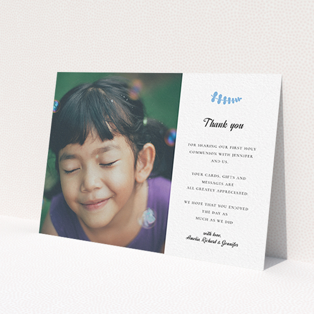 A communion thank you card design named 'Blue Fern'. It is an A6 card in a landscape orientation. It is a photographic communion thank you card with room for 1 photo. 'Blue Fern' is available as a flat card, with tones of white and blue.