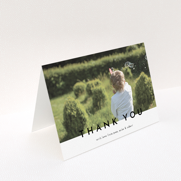 A communion thank you card named "Cross Border". It is an A5 card in a landscape orientation. It is a photographic communion thank you card with room for 1 photo. "Cross Border" is available as a folded card, with mainly white colouring.