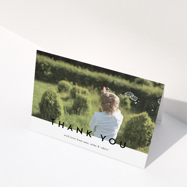 A communion thank you card named "Cross Border". It is an A5 card in a landscape orientation. It is a photographic communion thank you card with room for 1 photo. "Cross Border" is available as a folded card, with mainly white colouring.