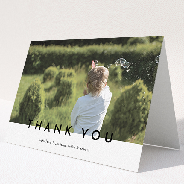 A communion thank you card named "Cross Border". It is an A5 card in a landscape orientation. It is a photographic communion thank you card with room for 1 photo. "Cross Border" is available as a folded card, with mainly white colouring.