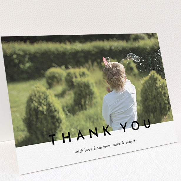 A communion thank you card named "Cross Border". It is an A5 card in a landscape orientation. It is a photographic communion thank you card with room for 1 photo. "Cross Border" is available as a folded card, with mainly white colouring.