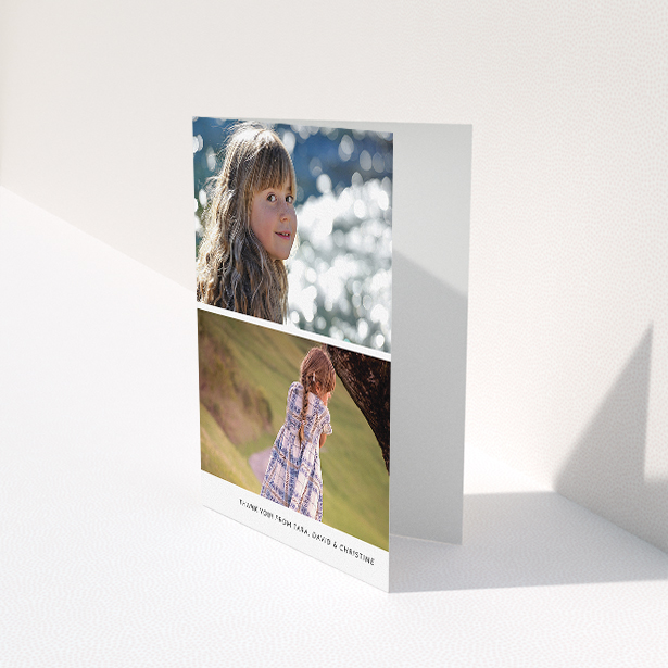 A communion thank you card named "Stacked Landscapes". It is an A5 card in a portrait orientation. It is a photographic communion thank you card with room for 2 photos. "Stacked Landscapes" is available as a folded card, with mainly white colouring.