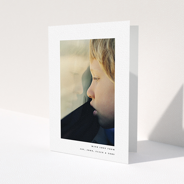 A communion thank you card template titled 'Thin Blue Frame'. It is an A6 card in a portrait orientation. It is a photographic communion thank you card with room for 1 photo. 'Thin Blue Frame' is available as a folded card, with mainly white colouring.