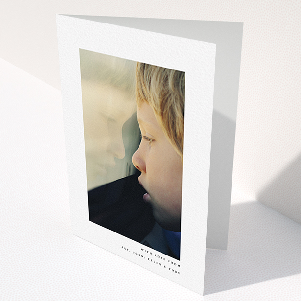 A communion thank you card template titled "Thin Blue Frame". It is an A6 card in a portrait orientation. It is a photographic communion thank you card with room for 1 photo. "Thin Blue Frame" is available as a folded card, with mainly white colouring.