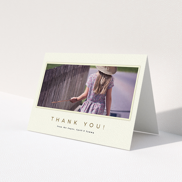 A communion thank you card named 'Torn Cream Frame'. It is an A6 card in a landscape orientation. It is a photographic communion thank you card with room for 1 photo. 'Torn Cream Frame' is available as a folded card, with mainly cream colouring.