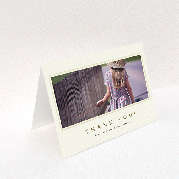 A communion thank you card named "Torn Cream Frame". It is an A6 card in a landscape orientation. It is a photographic communion thank you card with room for 1 photo. "Torn Cream Frame" is available as a folded card, with mainly cream colouring.