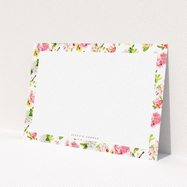A couples personalised note card design called 'Blurred blossom'. It is an A6 card in a landscape orientation. 'Blurred blossom' is available as a flat card, with tones of pink, green and yellow.