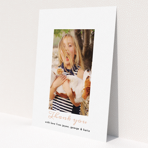 A first holy communion thank you card called 'Central Portrait'. It is an A5 card in a portrait orientation. It is a photographic first holy communion thank you card with room for 1 photo. 'Central Portrait' is available as a flat card, with tones of white and pink.