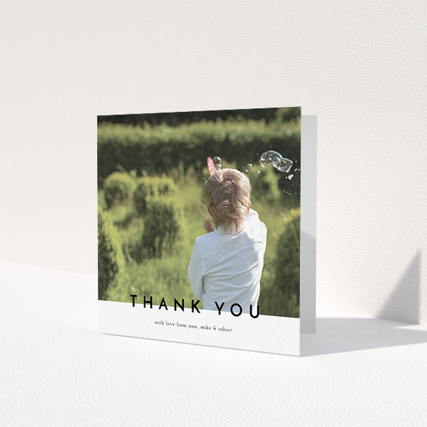 A first holy communion thank you card template titled 'Cross Border'. It is a square (148mm x 148mm) card in a square orientation. It is a photographic first holy communion thank you card with room for 1 photo. 'Cross Border' is available as a folded card, with mainly white colouring.