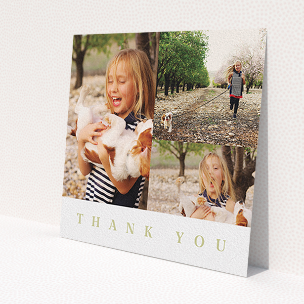 A first holy communion thank you card design named 'One and Two Half Frames'. It is a square (148mm x 148mm) card in a square orientation. It is a photographic first holy communion thank you card with room for 3 photos. 'One and Two Half Frames' is available as a flat card, with tones of white and gold.