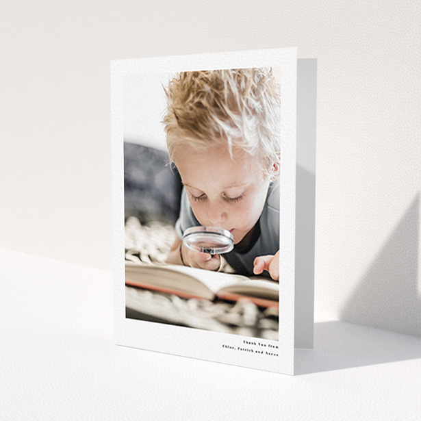 A first holy communion thank you card called 'Simple Portrait'. It is an A6 card in a portrait orientation. It is a photographic first holy communion thank you card with room for 1 photo. 'Simple Portrait' is available as a folded card, with mainly white colouring.