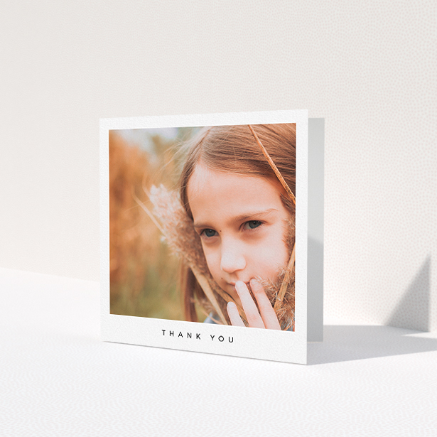 A first holy communion thank you card named 'Simple Thanks'. It is a square (148mm x 148mm) card in a square orientation. It is a photographic first holy communion thank you card with room for 1 photo. 'Simple Thanks' is available as a folded card, with mainly white colouring.