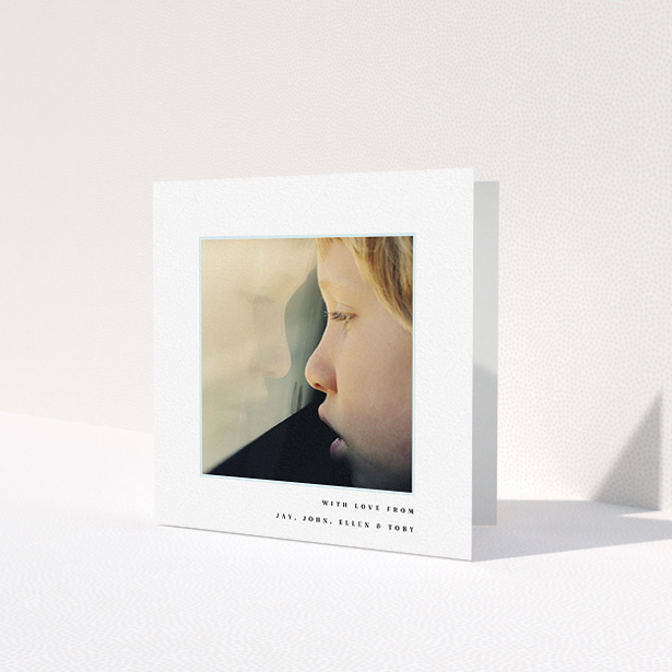 A first holy communion thank you card design titled 'Thin Blue Frame'. It is a square (148mm x 148mm) card in a square orientation. It is a photographic first holy communion thank you card with room for 1 photo. 'Thin Blue Frame' is available as a folded card, with mainly white colouring.