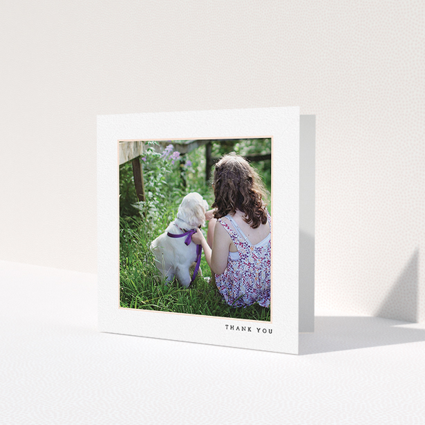 A first holy communion thank you card design called 'Thin Pink Frame'. It is a square (148mm x 148mm) card in a square orientation. It is a photographic first holy communion thank you card with room for 1 photo. 'Thin Pink Frame' is available as a folded card, with tones of white and pink.