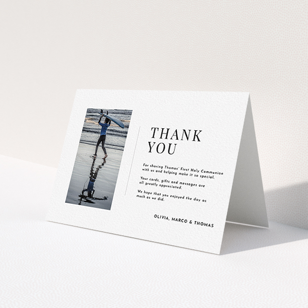A first holy communion thank you card design named 'Tiny Portrait'. It is an A6 card in a landscape orientation. It is a photographic first holy communion thank you card with room for 1 photo. 'Tiny Portrait' is available as a folded card, with mainly white colouring.