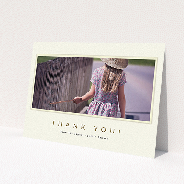 A first holy communion thank you card design titled 'Torn Cream Frame'. It is an A6 card in a landscape orientation. It is a photographic first holy communion thank you card with room for 1 photo. 'Torn Cream Frame' is available as a flat card, with mainly cream colouring.