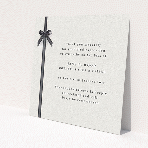 A funeral thank you card design named 'Tied gracefully'. It is a square (148mm x 148mm) card in a square orientation. 'Tied gracefully' is available as a flat card, with tones of pale cream and faded black.