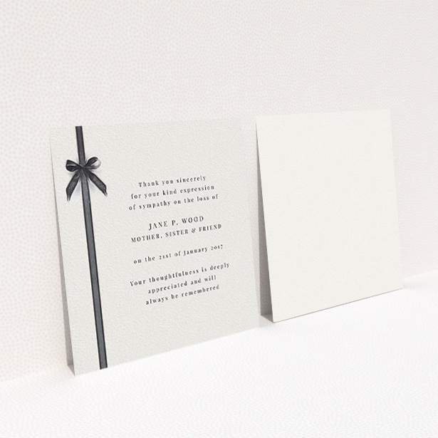 A funeral thank you card design named "Tied gracefully". It is a square (148mm x 148mm) card in a square orientation. "Tied gracefully" is available as a flat card, with tones of pale cream and faded black.