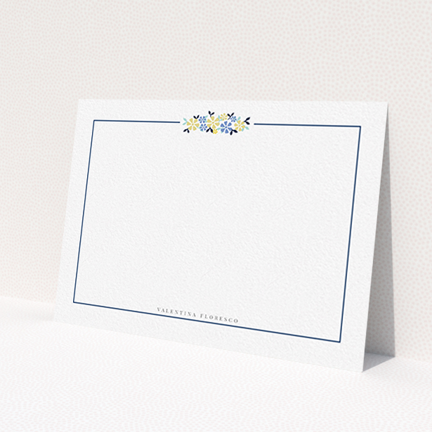 A ladies personalised note card design named 'Surrounded by flowers'. It is an A6 card in a landscape orientation. 'Surrounded by flowers' is available as a flat card, with tones of white and blue.