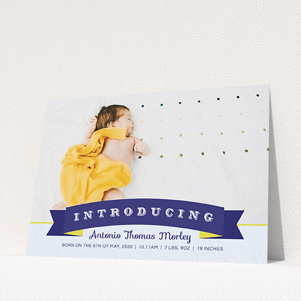 A new baby announcement card named "Big Banner". It is an A6 card in a landscape orientation. It is a photographic new baby announcement card with room for 1 photo. "Big Banner" is available as a flat card, with tones of blue, light blue and yellow.