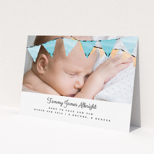 A new baby announcement card design titled 'Blue Bunting'. It is an A5 card in a landscape orientation. It is a photographic new baby announcement card with room for 1 photo. 'Blue Bunting' is available as a flat card, with tones of blue and white.