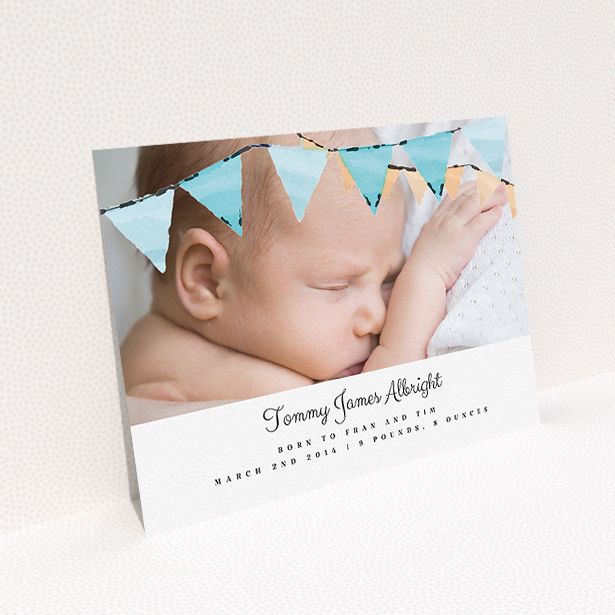 A new baby announcement card design titled "Blue Bunting". It is an A5 card in a landscape orientation. It is a photographic new baby announcement card with room for 1 photo. "Blue Bunting" is available as a flat card, with tones of blue and white.