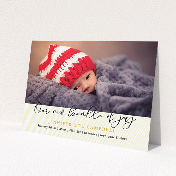 A new baby announcement card named 'Our New Bundle of Joy'. It is an A5 card in a landscape orientation. It is a photographic new baby announcement card with room for 1 photo. 'Our New Bundle of Joy' is available as a flat card, with tones of cream and gold.