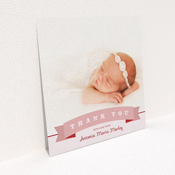 A new baby thank you card design called "Big Banner". It is a square (148mm x 148mm) card in a square orientation. It is a photographic new baby thank you card with room for 1 photo. "Big Banner" is available as a flat card, with tones of pink and white.