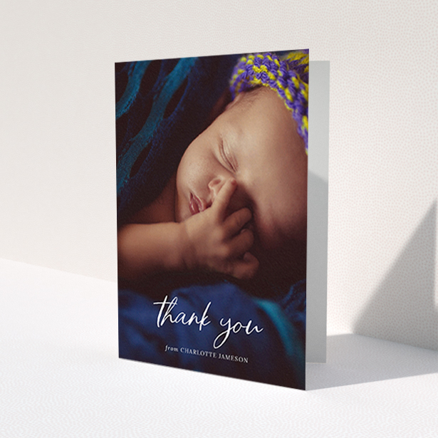 A new baby thank you card template titled 'Calligraphy Thanks'. It is an A6 card in a portrait orientation. It is a photographic new baby thank you card with room for 1 photo. 'Calligraphy Thanks' is available as a folded card, with mainly white colouring.