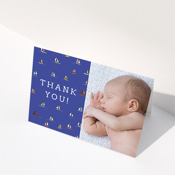 A new baby thank you card named "Cowes Week". It is an A6 card in a landscape orientation. It is a photographic new baby thank you card with room for 1 photo. "Cowes Week" is available as a folded card, with mainly blue colouring.