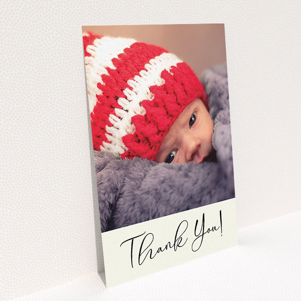 A new baby thank you card template titled "Cursive Thanks". It is an A5 card in a portrait orientation. It is a photographic new baby thank you card with room for 1 photo. "Cursive Thanks" is available as a flat card, with mainly cream colouring.