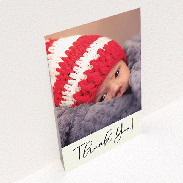 A new baby thank you card template titled "Cursive Thanks". It is an A5 card in a portrait orientation. It is a photographic new baby thank you card with room for 1 photo. "Cursive Thanks" is available as a flat card, with mainly cream colouring.