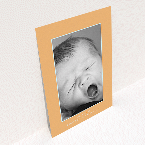 A new baby thank you card design named "Orange and Mint". It is an A6 card in a portrait orientation. It is a photographic new baby thank you card with room for 1 photo. "Orange and Mint" is available as a flat card, with tones of orange and blue.