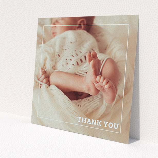 A new baby thank you card template titled 'Over Photo Frame'. It is a square (148mm x 148mm) card in a square orientation. It is a photographic new baby thank you card with room for 1 photo. 'Over Photo Frame' is available as a flat card, with mainly white colouring.