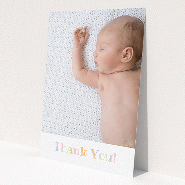 A new baby thank you card design named 'Pastel Thank You'. It is an A5 card in a portrait orientation. It is a photographic new baby thank you card with room for 1 photo. 'Pastel Thank You' is available as a flat card, with tones of white and green.