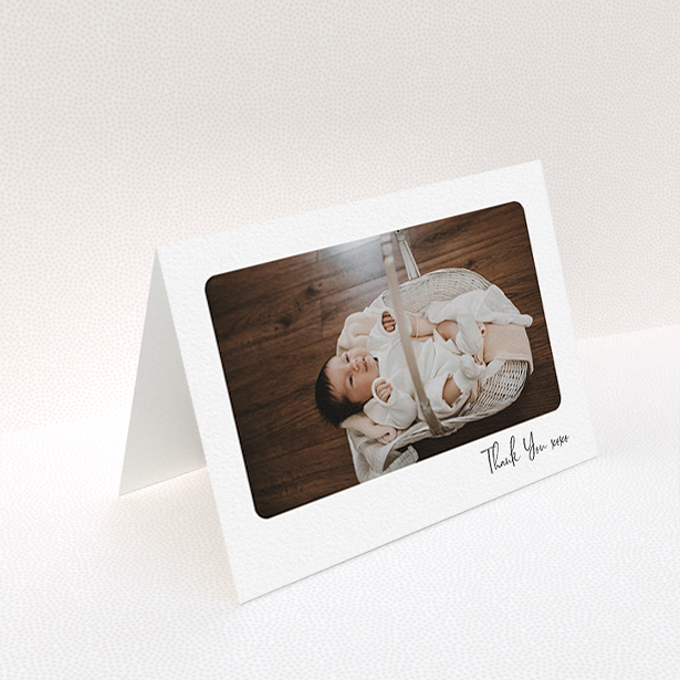 A new baby thank you card named "Rounded Thanks". It is an A6 card in a landscape orientation. It is a photographic new baby thank you card with room for 1 photo. "Rounded Thanks" is available as a folded card, with mainly white colouring.