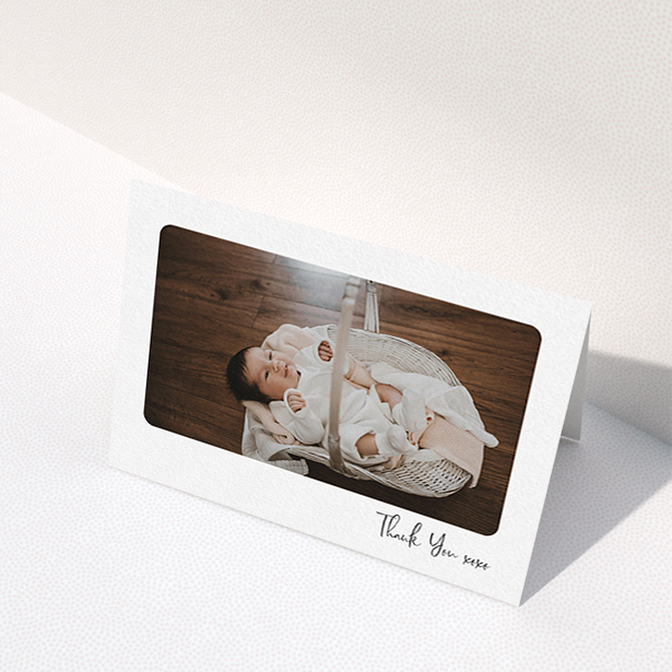 A new baby thank you card named "Rounded Thanks". It is an A6 card in a landscape orientation. It is a photographic new baby thank you card with room for 1 photo. "Rounded Thanks" is available as a folded card, with mainly white colouring.