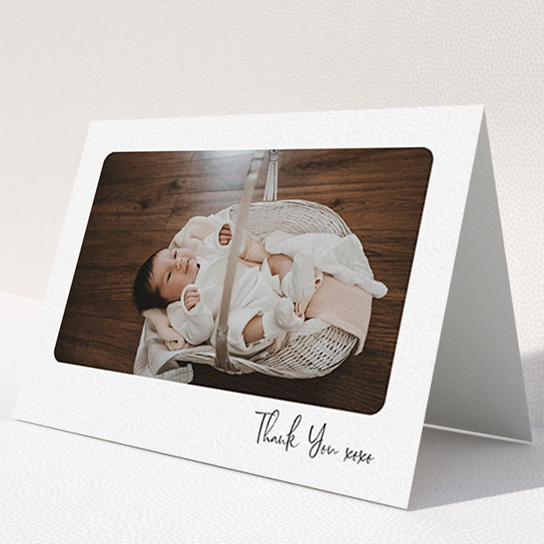 A new baby thank you card named "Rounded Thanks". It is an A6 card in a landscape orientation. It is a photographic new baby thank you card with room for 1 photo. "Rounded Thanks" is available as a folded card, with mainly white colouring.