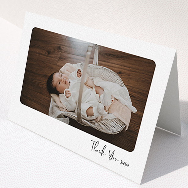 A new baby thank you card named "Rounded Thanks". It is an A6 card in a landscape orientation. It is a photographic new baby thank you card with room for 1 photo. "Rounded Thanks" is available as a folded card, with mainly white colouring.