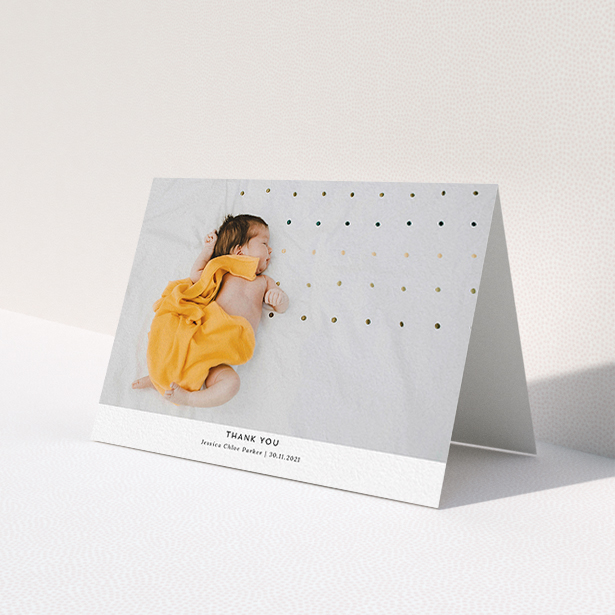 A new baby thank you card called 'Sans Serif'. It is an A6 card in a landscape orientation. It is a photographic new baby thank you card with room for 1 photo. 'Sans Serif' is available as a folded card, with mainly white colouring.