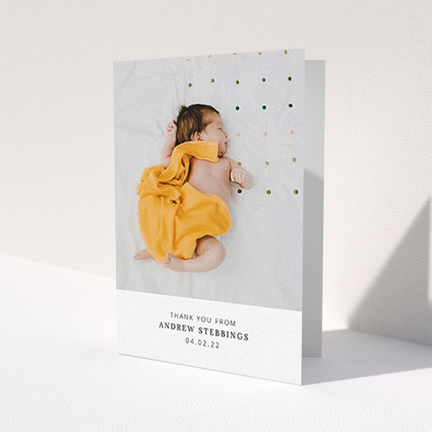 A new baby thank you card named 'Simple, Portrait Thank You'. It is an A6 card in a portrait orientation. It is a photographic new baby thank you card with room for 1 photo. 'Simple, Portrait Thank You' is available as a folded card, with mainly white colouring.