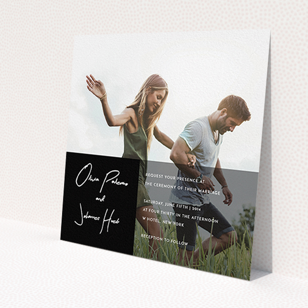 A personalised wedding invitation design named 'Black on black'. It is a square (148mm x 148mm) invite in a square orientation. It is a photographic personalised wedding invitation with room for 1 photo. 'Black on black' is available as a flat invite, with mainly black colouring.