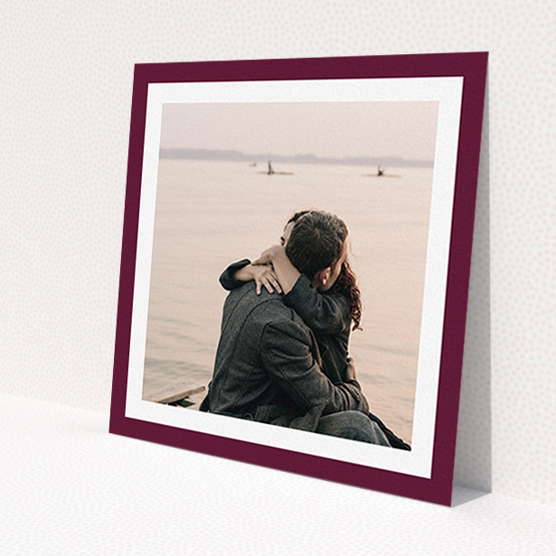 A personalised wedding invitation design called 'Classic Burgundy Photo Frame'. It is a square (148mm x 148mm) invite in a square orientation. It is a photographic personalised wedding invitation with room for 1 photo. 'Classic Burgundy Photo Frame' is available as a flat invite, with tones of burgundy and white.