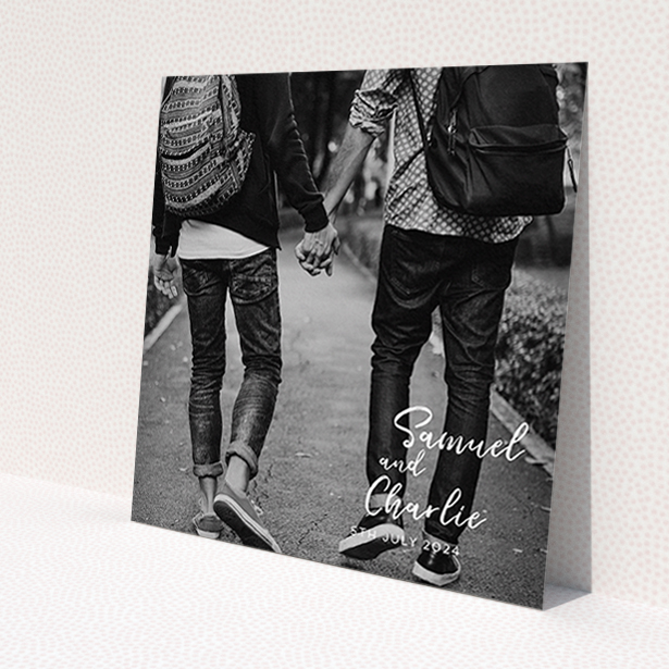A personalised wedding invitation design named 'Soho Script'. It is a square (148mm x 148mm) invite in a square orientation. It is a photographic personalised wedding invitation with room for 1 photo. 'Soho Script' is available as a flat invite, with mainly white colouring.