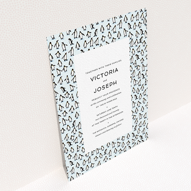 A personalised wedding invitation design titled "Tiny, Tiny Penguins". It is an A6 invite in a portrait orientation. "Tiny, Tiny Penguins" is available as a flat invite, with tones of blue and white.