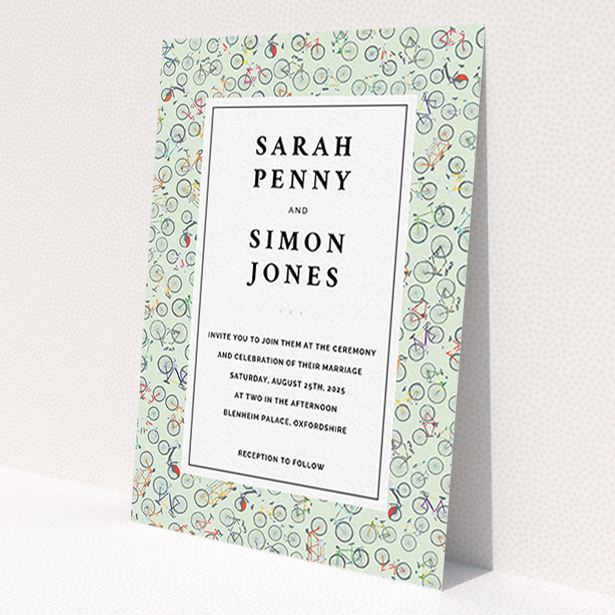 A personalised wedding invite design called 'Peloton'. It is an A6 invite in a portrait orientation. 'Peloton' is available as a flat invite, with tones of green, red and grey.