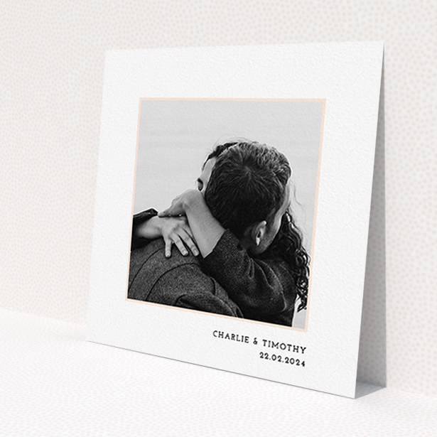A personalised wedding invite called 'Photo Centre'. It is a square (148mm x 148mm) invite in a square orientation. It is a photographic personalised wedding invite with room for 1 photo. 'Photo Centre' is available as a flat invite, with tones of white and pink.