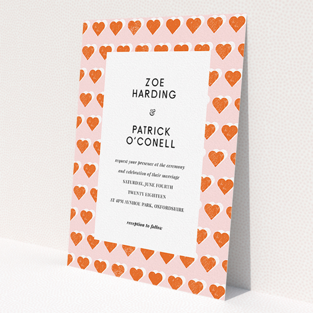 A personalised wedding invite design named 'Rustic Hearts'. It is an A5 invite in a portrait orientation. 'Rustic Hearts' is available as a flat invite, with tones of pink and orange.
