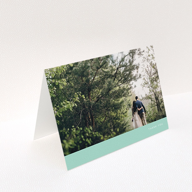 A photo wedding thank you card template titled "Simple Mint". It is an A6 card in a landscape orientation. It is a photographic photo wedding thank you card with room for 1 photo. "Simple Mint" is available as a folded card, with tones of green and white.